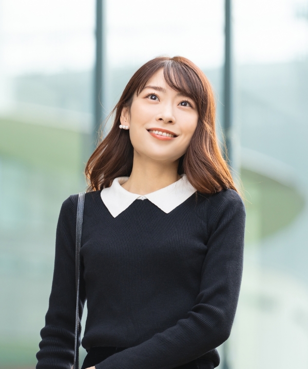 黒い洋服を着た女性が前を向いている写真